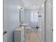 A cute blue bathroom features a cabinet, and a shower with a curtain at 909 E Markwood Ave, Indianapolis, IN 46227