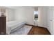 Bright bedroom featuring hardwood floors, an inflatable bed, and a patterned area rug at 909 E Markwood Ave, Indianapolis, IN 46227