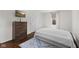 Clean bedroom features wood dresser, TV, and a patterned area rug on dark hardwood floors at 909 E Markwood Ave, Indianapolis, IN 46227