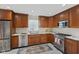 Well-equipped kitchen featuring stainless steel appliances, granite countertops, and custom cabinetry at 909 E Markwood Ave, Indianapolis, IN 46227