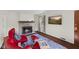 Charming living room with a stone fireplace, hardwood floors, and ample natural light at 909 E Markwood Ave, Indianapolis, IN 46227