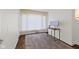 Compact office area with modern desk setup and neutral-toned rug on dark hardwood floors at 909 E Markwood Ave, Indianapolis, IN 46227