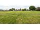 A large, beautifully maintained backyard with a shed, surrounded by mature trees and neighboring homes at 9159 E County Road 400 N, Brownsburg, IN 46112