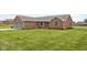 Inviting brick home with a lush green lawn, enhanced by beautiful landscaping and mature trees at 9159 E County Road 400 N, Brownsburg, IN 46112