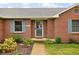 Close up on the entrance to a brick home with a well maintained yard and blue shutters at 9159 E County Road 400 N, Brownsburg, IN 46112