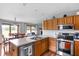 Bright kitchen showcasing stainless steel appliances, countertops, and an adjacent dining area at 9159 E County Road 400 N, Brownsburg, IN 46112