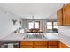 Kitchen sink beneath cabinets, with view into dining area with sliding doors at 9159 E County Road 400 N, Brownsburg, IN 46112