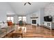 Bright living room with hardwood floors, fireplace, and vaulted ceilings and large windows at 9159 E County Road 400 N, Brownsburg, IN 46112