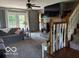 Comfortable living room boasts a cozy fireplace and staircase at 916 N County Road 500 E, Avon, IN 46123