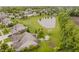 Aerial view showcasing a home with lush green yard, pond, gazebo, and a serene suburban neighborhood at 9598 N Mariners Crst, McCordsville, IN 46055