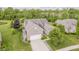 Brick home with well-manicured lawn, mature trees, and a paved driveway in a suburban neighborhood at 9598 N Mariners Crst, McCordsville, IN 46055