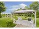 Backyard with a pond, lake, and gazebo with seating at 9598 N Mariners Crst, McCordsville, IN 46055