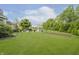 Large grassy backyard featuring a gazebo with patio furniture, garden space, and lush landscaping at 9598 N Mariners Crst, McCordsville, IN 46055