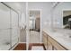 Bathroom featuring a glass enclosed shower, double sink vanity, and view to bedroom at 9598 N Mariners Crst, McCordsville, IN 46055