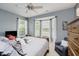 Bedroom featuring a large bay window, chair, ceiling fan, and dresser at 9598 N Mariners Crst, McCordsville, IN 46055