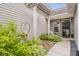 Inviting front entrance with a pergola, lush greenery, and charming brick walkway at 9598 N Mariners Crst, McCordsville, IN 46055