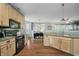 Open kitchen features neutral cabinets, stainless appliances and open access to dining room at 9598 N Mariners Crst, McCordsville, IN 46055