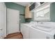 Functional laundry room with cabinets and updated appliances at 9598 N Mariners Crst, McCordsville, IN 46055