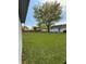 Overlooking a grassy backyard with mature trees and well-maintained lawn at 1011 N 10Th St, Elwood, IN 46036