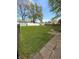 Landscaped backyard with grass, mature trees, a shed and privacy fencing at 1011 N 10Th St, Elwood, IN 46036