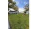 Well maintained fenced backyard featuring mature trees, a shed, and fire pit at 1011 N 10Th St, Elwood, IN 46036