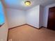 A carpeted bedroom featuring one window and a door at 1011 N 10Th St, Elwood, IN 46036