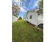 Grassy lawn and the side of a house with an air conditioning unit at 1011 N 10Th St, Elwood, IN 46036