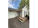 Front entrance with brick steps leading to the front door and attached garage at 1011 N 10Th St, Elwood, IN 46036