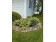 Rock garden bed with flowers and other plants at 1011 N 10Th St, Elwood, IN 46036