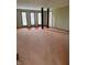 Spacious living room featuring neutral carpet, three large windows and decorative wood support pillars at 1011 N 10Th St, Elwood, IN 46036