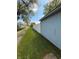 View of the side yard with a white fence and greenery shows property boundary at 1011 N 10Th St, Elwood, IN 46036