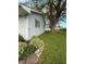 A glimpse of the house siding with landscaping near a tree at 1011 N 10Th St, Elwood, IN 46036