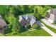 Aerial view of the property, highlighting the landscaping and mature trees at 10390 Tremont Dr, Fishers, IN 46037