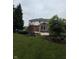 Backyard view of the two-story home featuring brick facade and a well-manicured lawn at 10390 Tremont Dr, Fishers, IN 46037