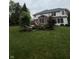 Backyard view of the two-story home featuring brick facade and a well-manicured lawn at 10390 Tremont Dr, Fishers, IN 46037