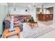 A comfortable basement living room area boasts a patterned rug and direct access to the bar at 10390 Tremont Dr, Fishers, IN 46037