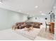Spacious basement living room features recessed lighting, carpet, and a large patterned sectional sofa at 10390 Tremont Dr, Fishers, IN 46037