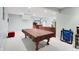 Spacious carpeted basement rec room with a pool table, access to the wet bar and seating areas at 10390 Tremont Dr, Fishers, IN 46037