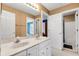 Bright bathroom with double sinks, a large mirror, and access to the shower and bedroom at 10390 Tremont Dr, Fishers, IN 46037