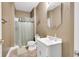 Full bathroom features a shower with curtain and single sink vanity with neutral walls and flooring at 10390 Tremont Dr, Fishers, IN 46037