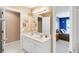 Bathroom featuring a double sink vanity with a large mirror and neutral walls at 10390 Tremont Dr, Fishers, IN 46037