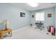 A cozy bedroom features a window, carpet and light blue painted walls with decorative art at 10390 Tremont Dr, Fishers, IN 46037
