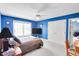 Spacious bedroom features a ceiling fan, plush carpet, and natural light from a large window at 10390 Tremont Dr, Fishers, IN 46037