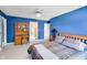 Cozy bedroom featuring a ceiling fan, a desk with shelving, and a comfortable bed at 10390 Tremont Dr, Fishers, IN 46037