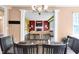 Dining room view leading into the living room with fireplace and view from the dining table at 10390 Tremont Dr, Fishers, IN 46037