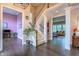 Elegant foyer with dark hardwood floors, staircase and views into the living room and other rooms, providing a grand entrance at 10390 Tremont Dr, Fishers, IN 46037
