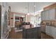 Kitchen with updated cabinets, island, and view of the dining area and sunroom at 10390 Tremont Dr, Fishers, IN 46037