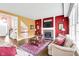Bright living room with fireplace, hardwood floors, and staircase at 10390 Tremont Dr, Fishers, IN 46037