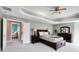 Comfortable main bedroom with neutral walls, trey ceiling, and elegant furniture at 10390 Tremont Dr, Fishers, IN 46037
