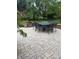 View of the patio featuring a stone surface, a seat wall, and outdoor furniture at 10390 Tremont Dr, Fishers, IN 46037